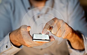 Close up of young man hands using smartphone in Phone Addiction and Mobile Gaming concept