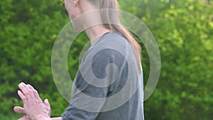 Close-up of a young man in indian clothes and pants alladin practicing qigong while doing exercises while working with