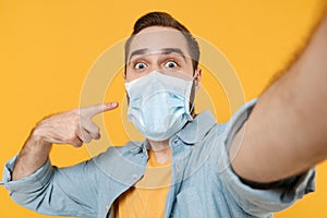 Close up of young man isolated on yellow background. Epidemic pandemic coronavirus 2019-ncov sars covid-19 flu virus