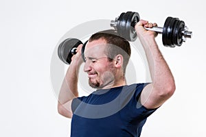 Close up of young man lifting weights