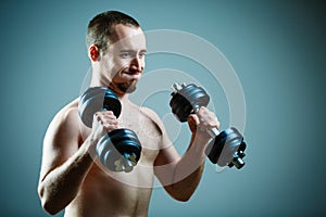 Close up of young man lifting weights