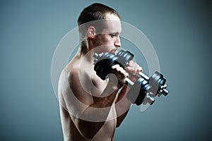 Close up of young man lifting weights