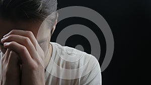 Close up of Young man praying to God. Concept of faith and religion