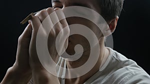 Close up of Young man praying to God. Concept of faith and religion