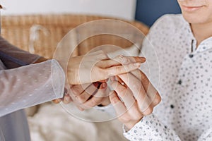 Close up young man putting wedding ring on woman bride finger, loving boyfriend proposing marriage to girlfriend