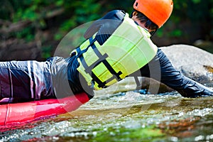 Close-up of young man is rafting on the river.