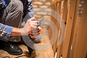 Close-up of a young man replacing drill bits and tightening drill head photo