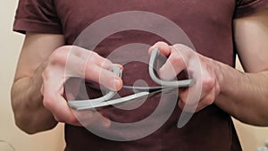 Close up of a young man's hand as he shuffles a deck of cards. Young croupier shuffles a deck of cards before playing