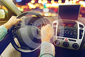 Close up of young man with tablet pc driving car