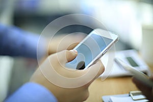 Close up of a young man using mobile smart phone