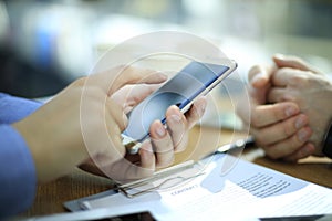 Close up of a young man using mobile smart phone