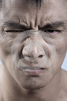 Close up of young mans face, irritated