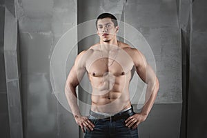 Close up of young muscular man lifting weights