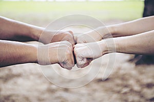 Close up of Young People Smacking Punch Hands Together