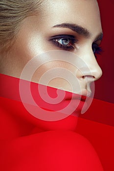 Close-up of young sexy blonde model with bright make-up. Smokey eyes, artistic image. Beauty concept. Vertical view.
