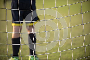 Close up of a young soccer goalie goalkeeper during the match.