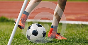 Close-up of Young Soccer Player Kicking Ball on Soccer Field. Football Corner Kick on the Pitch