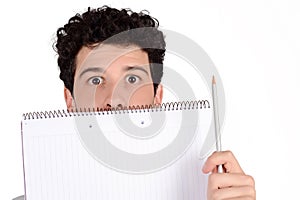 Student holding notebook and pencil.