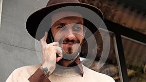 Close-up young stylish man in casual clothes talking on phone