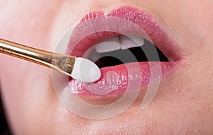 Young Woman Applying Make-up On Lips