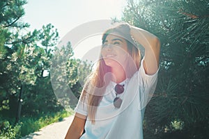 Close-up young woman with beautiful face features enjoying sun