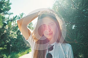 Close-up young woman with beautiful face features enjoying sun