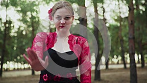 CLose up of young woman are dancing Traditional Spanish dance in summer forest