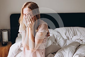 Close up young blonde woman feeling upset, sad, unhappy or disappoint crying lonely in bedroom. Emotional shock and life photo