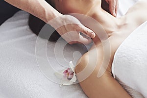 Close-up of a young woman gets a massage at the beauty salon. Procedures for skin and body.