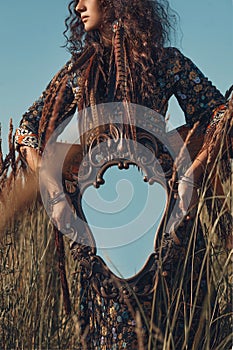 Close up of young woman hands holding mirror outdoors