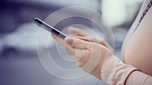 Close up of young woman hands texting messages on mobile phone