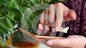 Close-up of young woman hands typing sms