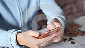 Close-up of young woman hands typing sms