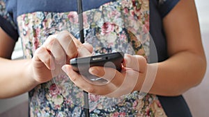 Close-up of young woman hands typing sms