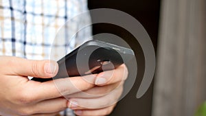 Close-up of young woman hands typing sms