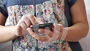 Close-up of young woman hands typing sms