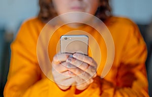 Close up of young woman hands using smartphone in Phone Addiction and Mobile Gaming concept