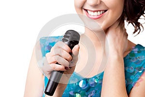 Close up young woman holding microphone