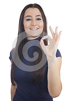 Close-up of a young woman making OK sign
