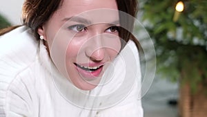 Close up of a young woman making a wish by covering her face with both hands.