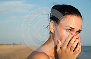 Close-up of a young woman with red eye rubbing irritated sensi