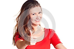 Close-up of a young woman showing thumbs up