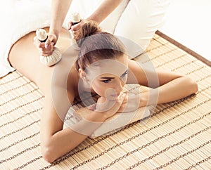 Close-up of young woman in spa. Traditional healing therapy and massaging treatments.