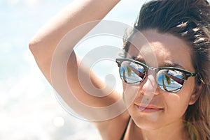Close-up of a young woman with sunglasses sunlight