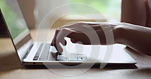 Close up young woman typing on computer keyboard.