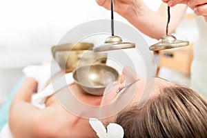 Sound massage with singing bowls and cymbals photo