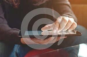 Close up young woman using tablet at a cafe