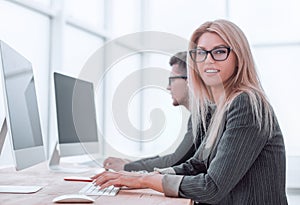 close up. a young woman works in a computer room.