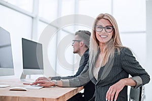 close up. a young woman works in a computer room.