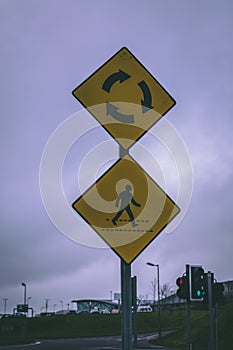 Close up of a zebra crossing and roundabout road signs